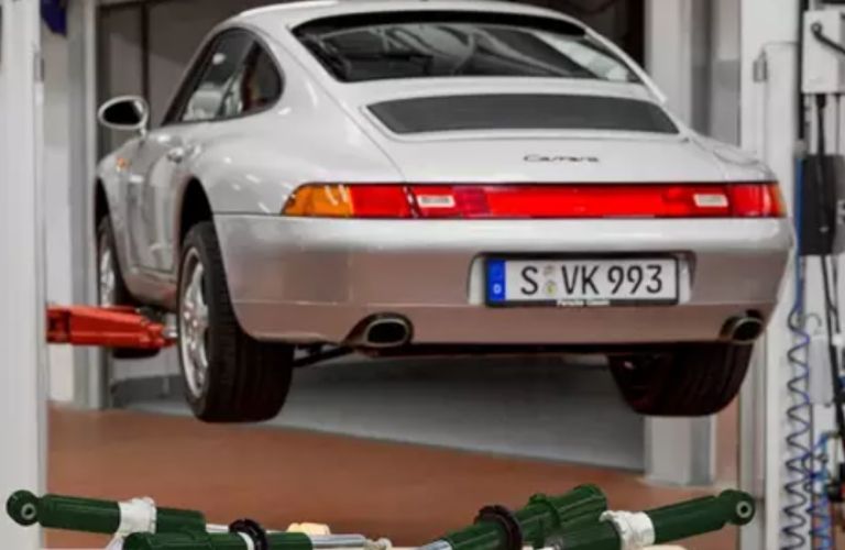 a Porsche hanging at a service center
