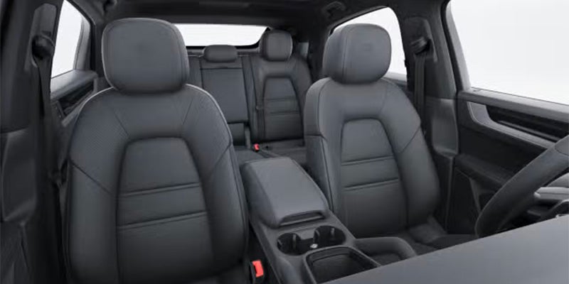 Interior view of car showing dark gray leather seats for front passengers and the second row.