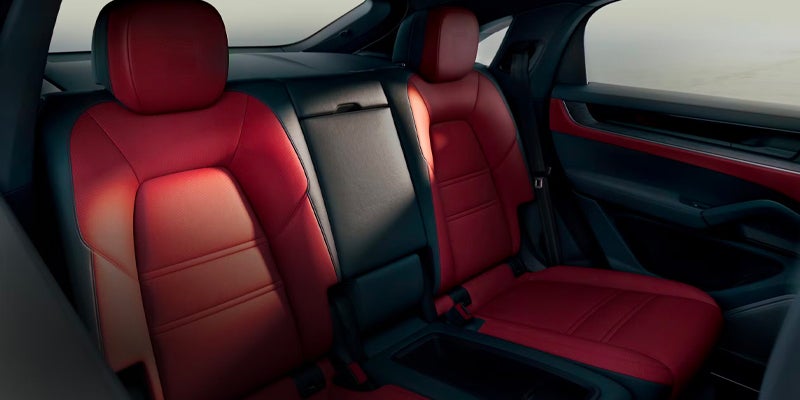 Two-tone red and black leather rear seats and interior of a car.