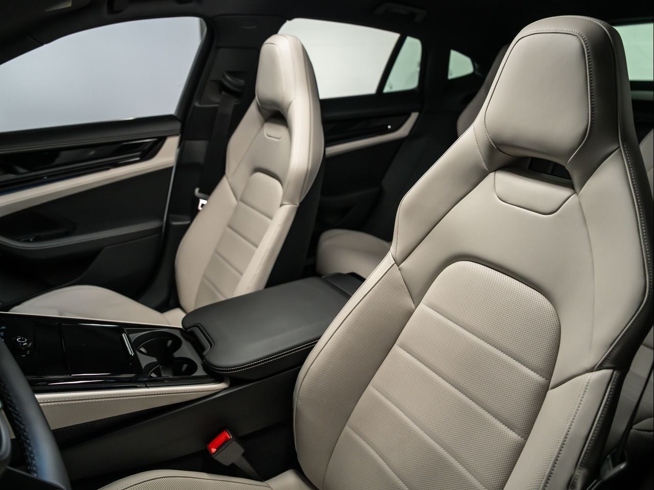 Light-colored, perforated leather interior with two front bucket seats and back seats visible.
