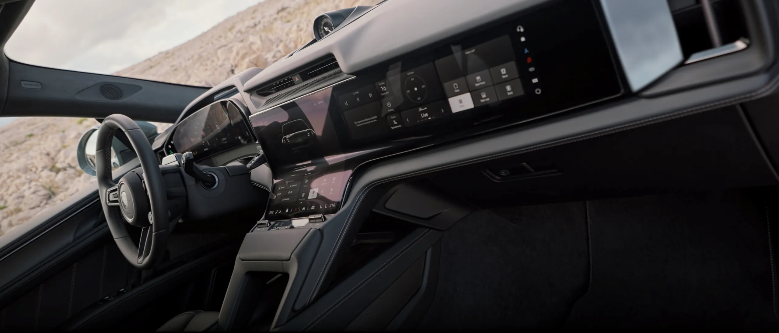 Cayenne interior with steering wheel and curved display area.