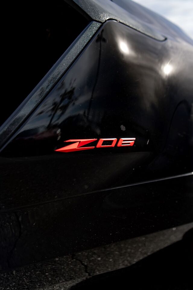 A black car door displays a red and silver 'ZO6' emblem.