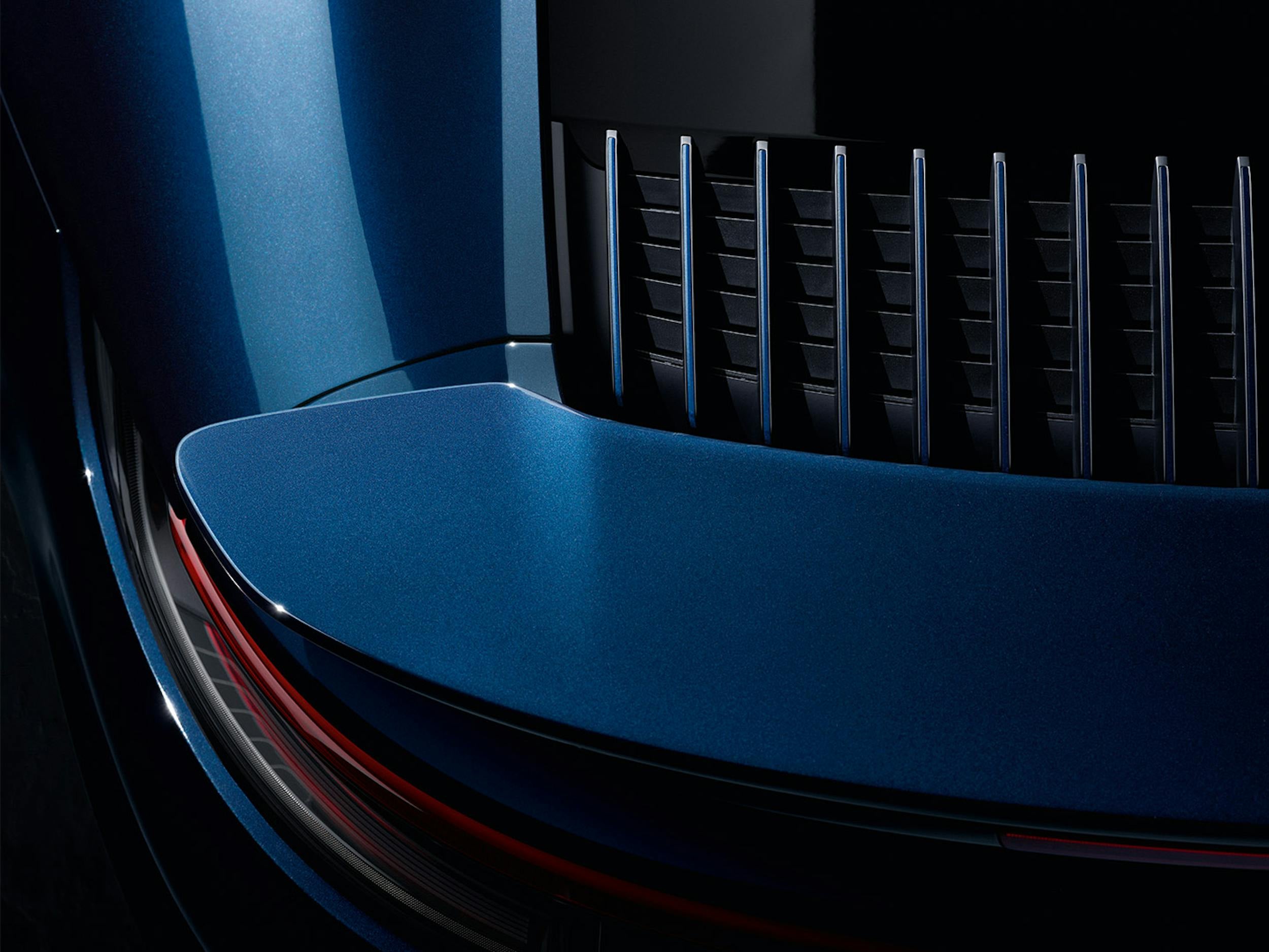 Close-up of a blue Porsche vehicle showing its bodywork and exterior finish.